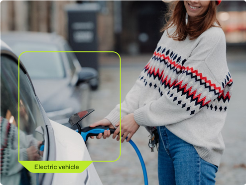 a woman charging an electric car